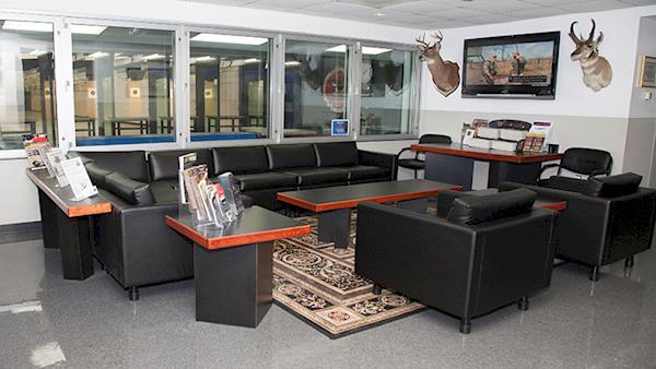 Comfortable Lounge with Leather Chairs and Windows Looking Out To the Indoor NRA Range